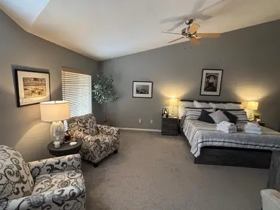 a bedroom with a bed and a couch and a chair at Unwind in Style in this stunning townhome retreat in Superior