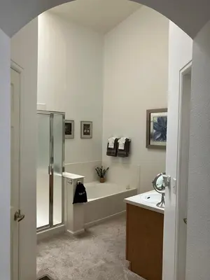 a bathroom with a tub and a sink and a shower at Unwind in Style in this stunning townhome retreat in Superior