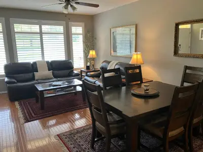 a living room with a table and a couch at Unwind in Style in this stunning townhome retreat in Superior