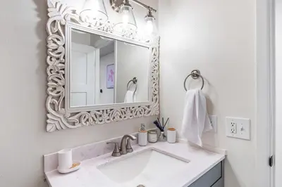 a bathroom with a white sink and a mirror at Stylish House with Hot Tub, Fire Pit Pool table near Denver in Arvada