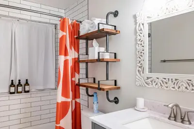 a bathroom with a orange shower curtain and a sink at Stylish House with Hot Tub, Fire Pit Pool table near Denver in Arvada