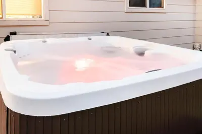 a large white bath tub sitting in a house at Stylish House with Hot Tub, Fire Pit Pool table near Denver in Arvada