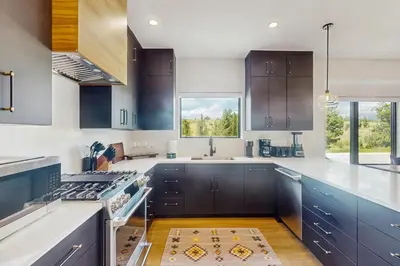 a kitchen with dark blue cabinets and a sink at Moose Mountain Lodge in Fraser