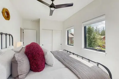 a bedroom with a bed with pillows and a window at Moose Mountain Lodge in Fraser