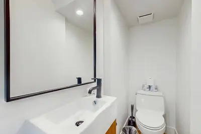 a bathroom with a white sink and a mirror at Moose Mountain Lodge in Fraser