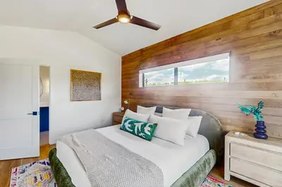 a bedroom with a bed and a ceiling fan at Moose Mountain Lodge in Fraser