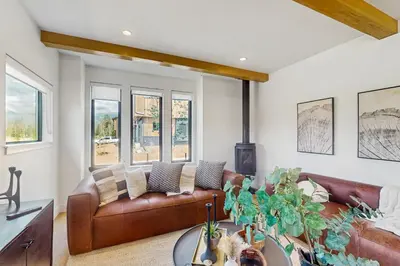 a living room with a brown leather couch at Moose Mountain Lodge in Fraser