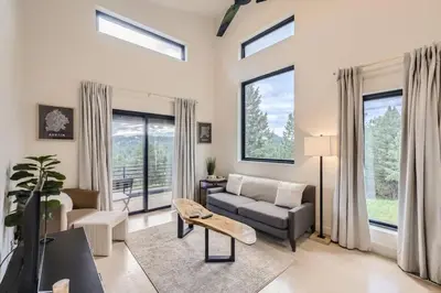 a living room with a couch and a tv at Pinebox at Evergreen Modern 20Acres -Serene-Creek in Evergreen