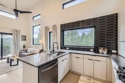 a kitchen with a sink and a large window at Pinebox at Evergreen Modern 20Acres -Serene-Creek in Evergreen
