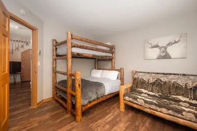 a bedroom with a bunk bed and a couch at Bright & Spacious Mtn Retreat in Fraser