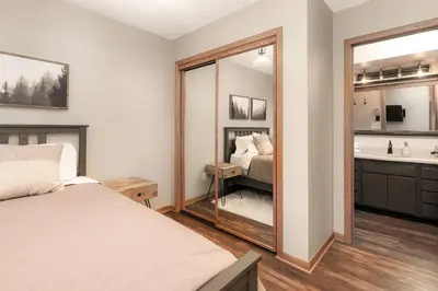 a bedroom with a mirror and a bed and a sink at Bright & Spacious Mtn Retreat in Fraser