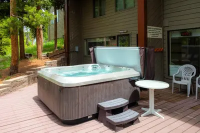 a jacuzzi tub sitting outside of a house at Bright & Spacious Mtn Retreat in Fraser