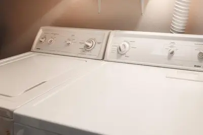 two washing machines sitting on top of a white refrigerator at Bright & Spacious Mtn Retreat in Fraser