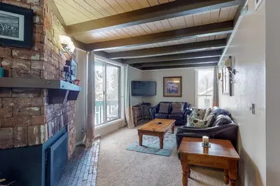 a living room with a couch and a fireplace at Lodge Pole Condo in Silverthorne