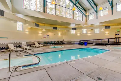 a large indoor pool in a building with a large ceiling at Lodge Pole Condo in Silverthorne