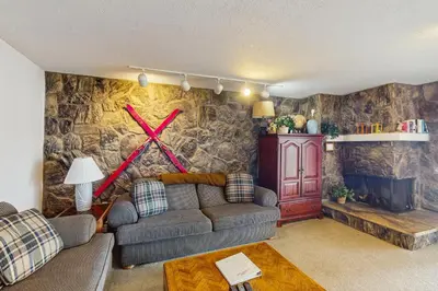 a living room with a couch and a x on the wall at Lake Cliffe 209F in Dillon