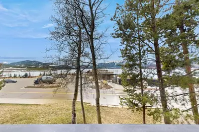 a group of trees in front of a parking lot at Lake Cliffe 209F in Dillon