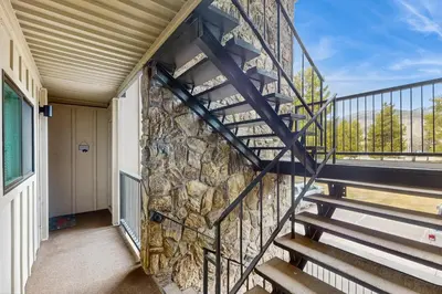 a staircase in a building with a stone wall at Lake Cliffe 209F in Dillon