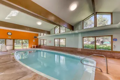a pool in a house with a large room with windows at Lake Cliffe 209F in Dillon