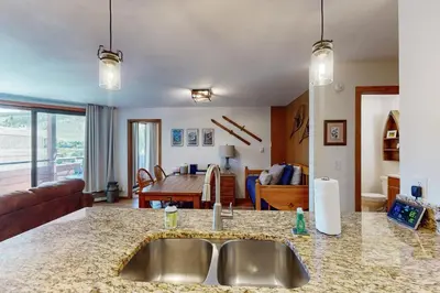 a kitchen with a sink and a living room at Marina Place 137 in Dillon