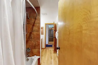 a bathroom with a shower and a toilet next to a door at Marina Place 137 in Dillon