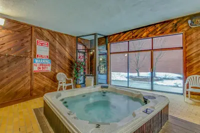a jacuzzi tub in a room with wooden walls at Marina Place 137 in Dillon