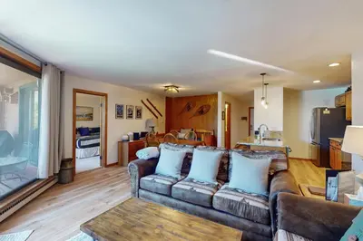 a living room with a couch and a kitchen at Marina Place 137 in Dillon