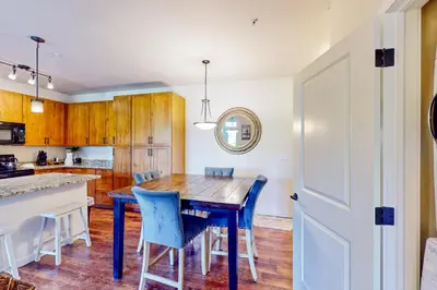 a kitchen with a wooden table and blue chairs at Granby Ranch H103 in Granby