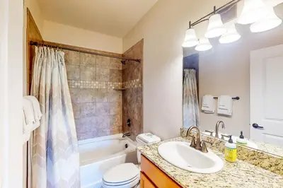 a bathroom with a sink and a toilet and a tub at Granby Ranch H103 in Granby