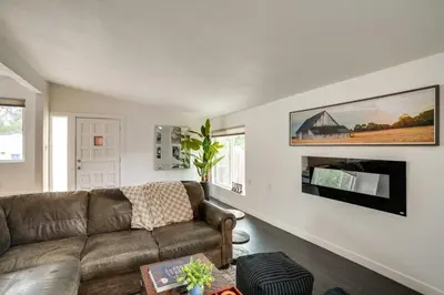 a living room with a couch and a tv at Game Room and Fire Pit Family-Friendly Loveland Gem in Loveland