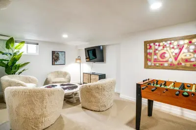 a living room with a foosball table and chairs at Game Room and Fire Pit Family-Friendly Loveland Gem in Loveland