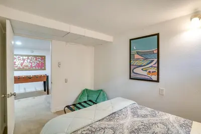 a bedroom with a bed and a painting on the wall at Game Room and Fire Pit Family-Friendly Loveland Gem in Loveland