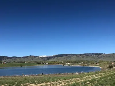 a view of a lake with mountains in the background at New! Cozy north Boulder guesthouse! in Boulder