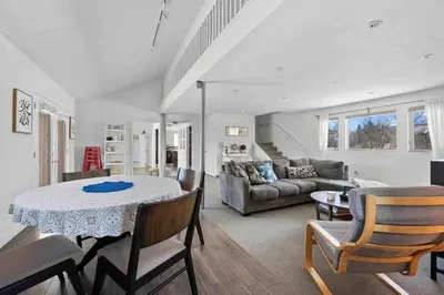 a living room with a table and a couch at New! Cozy north Boulder guesthouse! in Boulder
