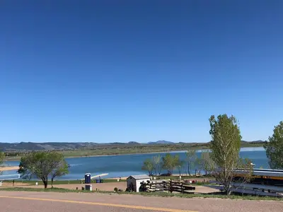 a train is parked next to a lake at New! Cozy north Boulder guesthouse! in Boulder