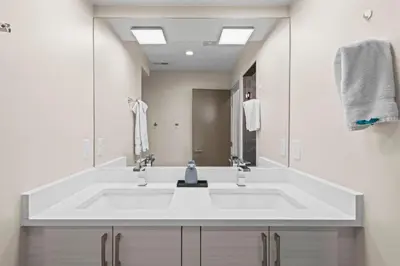 a white bathroom with a sink and a mirror at Modern Townhome for long stays Near Sloans Lake in Denver