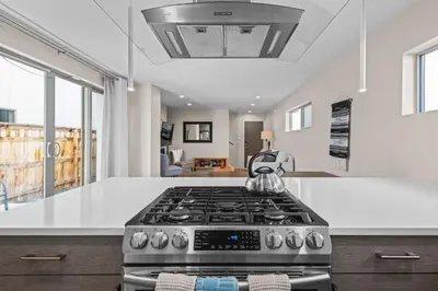 a kitchen with a stove top oven in a room at Modern Townhome for long stays Near Sloans Lake in Denver
