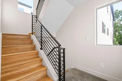 a staircase in a house with white walls and a window at Modern Townhome for long stays Near Sloans Lake in Denver
