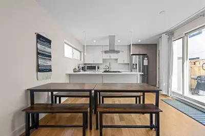 a kitchen with a wooden table and two benches at Modern Townhome for long stays Near Sloans Lake in Denver