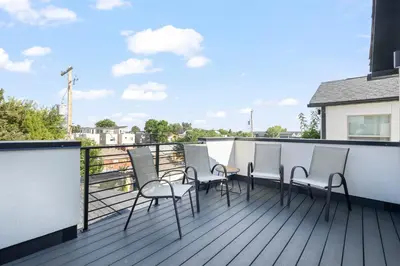 a row of chairs sitting on a balcony at Modern Townhome for long stays Near Sloans Lake in Denver