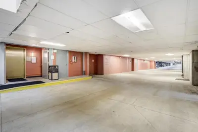 an empty room with a large room with orange walls at Gateway Studio - Pool, Hot Tub, Walk to Slopes in Keystone