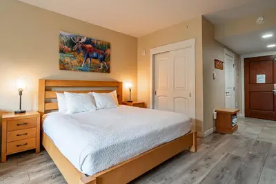 a bedroom with a bed and a painting on the wall at Founders Pointe 4569 Ski In Ski Out Winter Park Resort in Winter Park