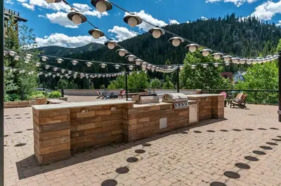 a patio with a bar with lights on it at Founders Pointe 4569 Ski In Ski Out Winter Park Resort in Winter Park
