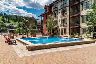 a swimming pool in front of a building at Founders Pointe 4569 Ski In Ski Out Winter Park Resort in Winter Park