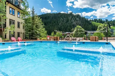 a large swimming pool in the middle of a resort at Founders Pointe 4569 Ski In Ski Out Winter Park Resort in Winter Park