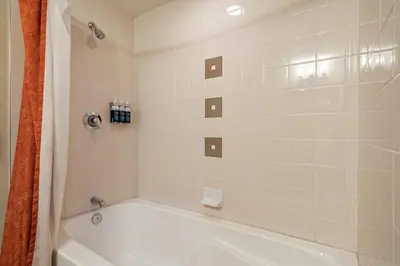 a bathroom with a white tub and a shower at Founders Pointe 4569 Ski In Ski Out Winter Park Resort in Winter Park