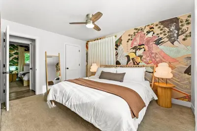 a bedroom with a large painting on the wall at 5BD Japanese-Themed w/ Hot Tub, Movie Room & Games in Arvada