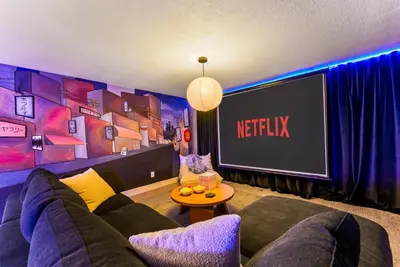 a living room with a couch and a tv at 5BD Japanese-Themed w/ Hot Tub, Movie Room & Games in Arvada
