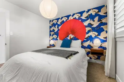 a bedroom with a large bed with a red umbrella at 5BD Japanese-Themed w/ Hot Tub, Movie Room & Games in Arvada