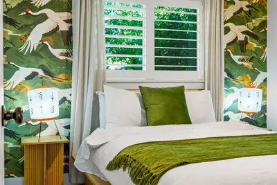 a bedroom with a bed and a window with bird wallpaper at 5BD Japanese-Themed w/ Hot Tub, Movie Room & Games in Arvada
